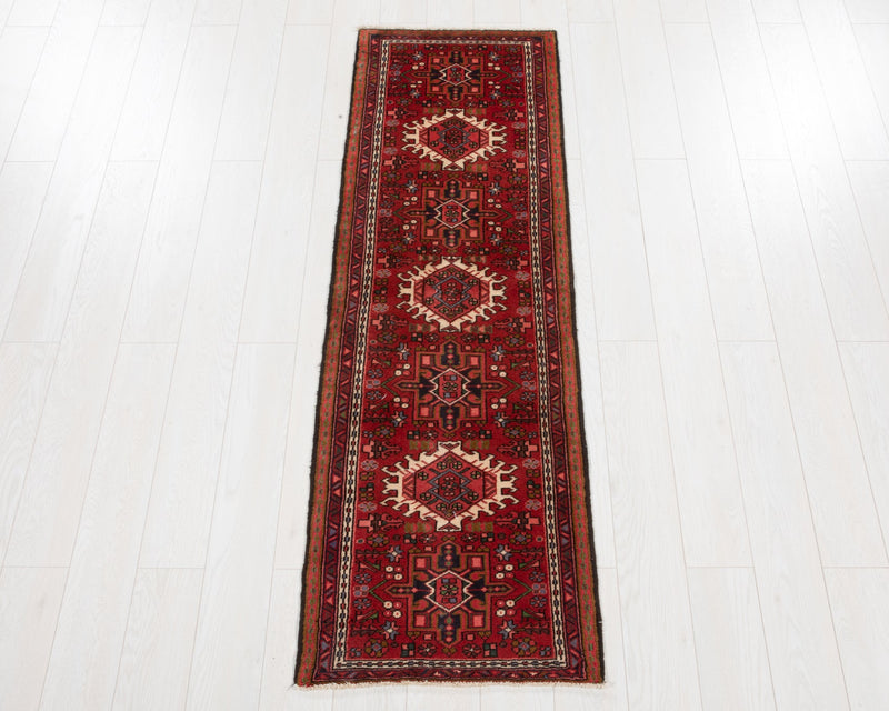 Red patterned rug on a white wooden floor